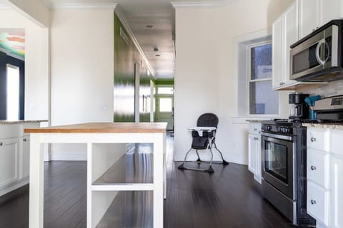 Polished floors and stainless steal appliances in this beautiful kitchen