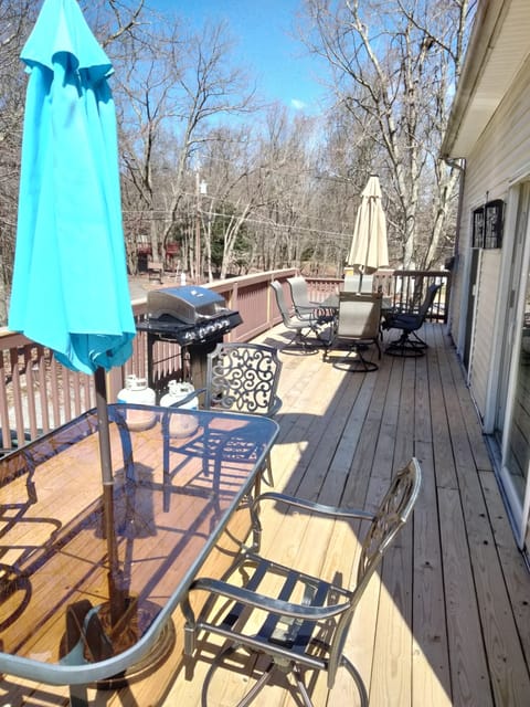 huge wrap around deck with gas grill and 2 propane tanks