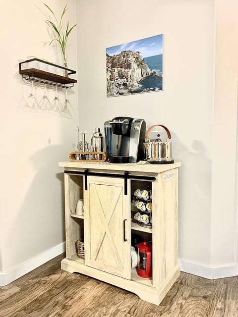 Coffee and cocktail bar with keurig, kettle, bartender set, glasses and more.