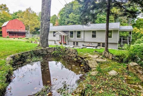 Beautiful pond and brook on side of house.