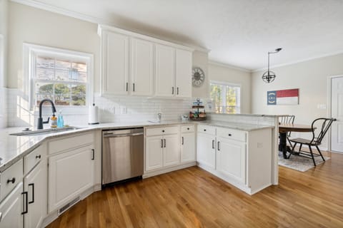 Bright, open-concept kitchen with natural light and seamless flow into the adjoining breakfast space.