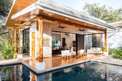 Beautiful terrace with swing by pool.