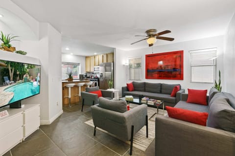 Sophisticated living room design with two sofas that open to full size beds, 50” 4K TV, beautiful decor, and so much more!