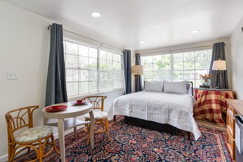 The space features an indoor table and chairs, and large windows that let in lots of natural light. You will love it!