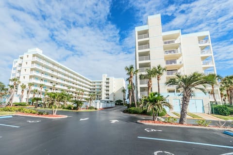 Sandcastles building welcomes you with its lush entry and beachside vibe.