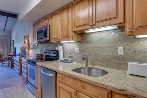 Fully equipped kitchen with stainless steel appliances and granite countertops.