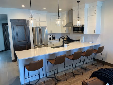 Comfortable seating for five at the kitchen island. Plus 8 more at dining table.
