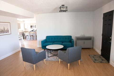 half of living room with sofa sleeper and game cabinet