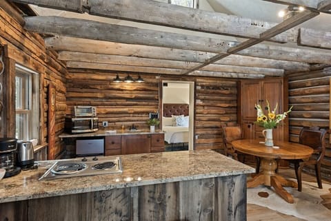 The kitchenette in our historic cabin is perfect for light cooking with a 2-burner stove, mini fridge and freezer, microwave, sink, and toaster.