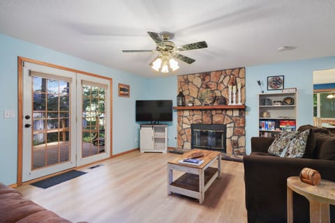 Living room with reclining sofa and smart tv.