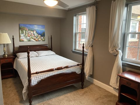 Bedroom with double bed, overlooking lovely treed courtyard.