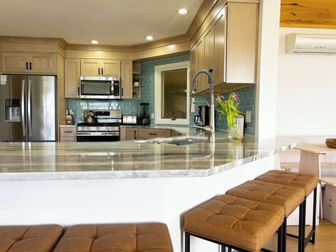 Everything you need to cook and gather, from high-end appliances to spacious island seating.