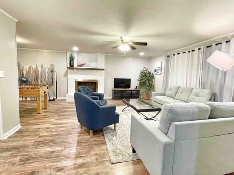 Open living room with fireplace, smart TV, and comfortable seating