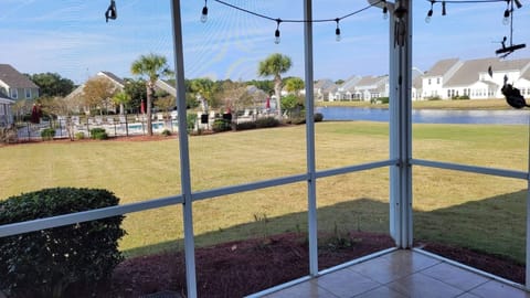 View of backyard area and pool from back screened in patio.