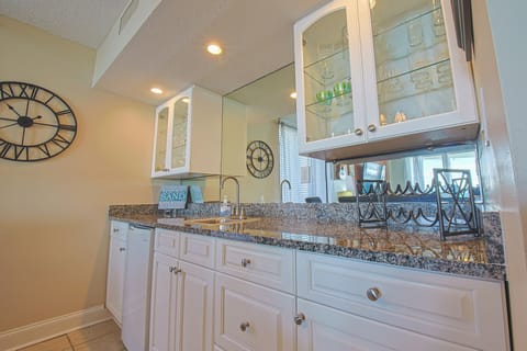 Wet bar with sink and mini-refrigerator.