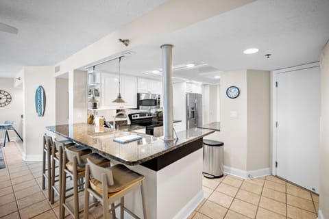 Kitchen bar has seating for 4 people.