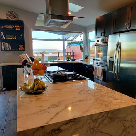 Cooktop island with 6 burner cooktop and waterfall end