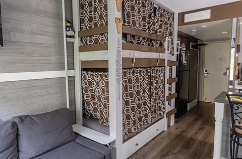 The mini twin bunk beds (75"L x 30"W) with privacy curtains.