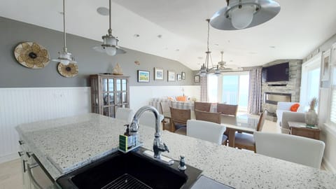 Kitchen opens to dining area and living room beyond