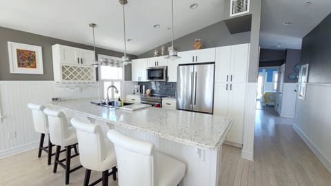 Kitchen with counter seating and stainless appliances