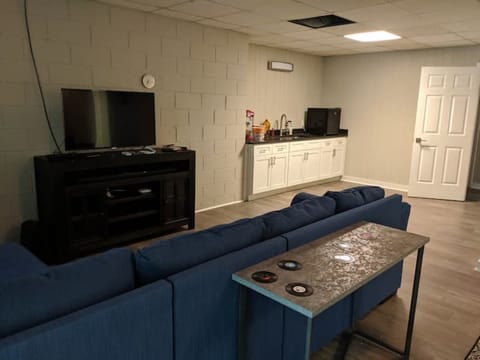 Playroom downstairs with TV, darts, air hockey, popcorn maker, and mini fridge