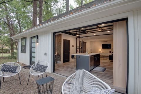 Open glass garage door to outside sitting area