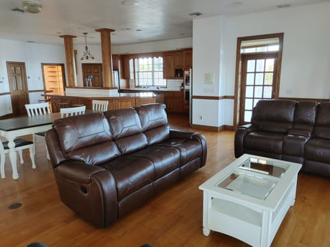 Main Dining table and large comfy reclining sofas.