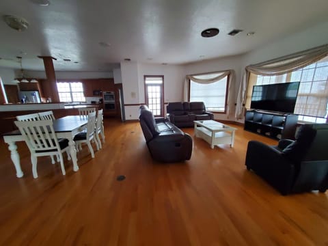 Main Dining table with six chairs, large comfy reclining sofas.