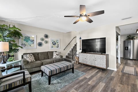 Carefree living room with stairs leading to 3 upstairs bedrooms and bath 