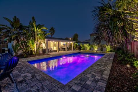 Backyard lit up at night for resort style vibes