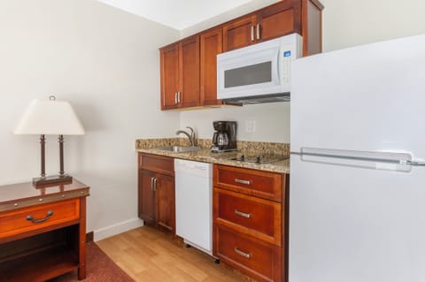 Prepare quick snacks with microwave, fridge, sink, and coffee.