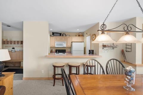 Plenty of seating with barstools and dining room table.