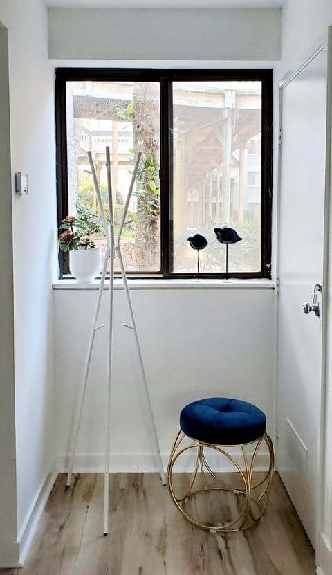 Hallway. A space to hang your outerwear and a stool to sit down to put on shoes.