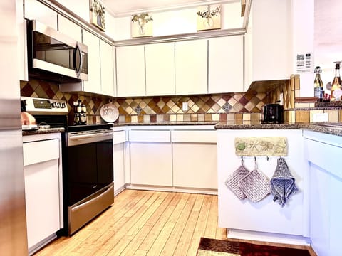 Kitchen open to living space and outdoor patio area.