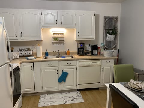 Full operational kitchen with dishwasher, full size refrigerator.