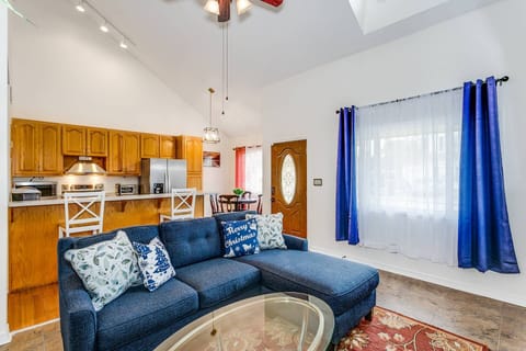 Open concept living room and dining area with multiple windows and a skylight
