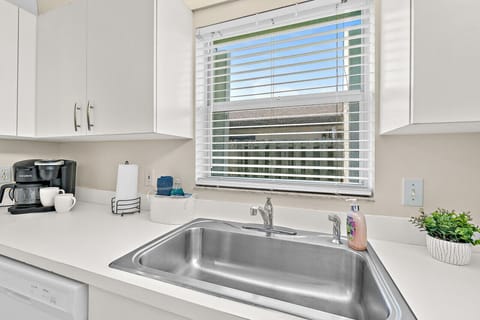 Fully equipped kitchen with flat stove top, refrigerator and freezer, dishwasher, coffee maker and more. (food and coffee not provided)