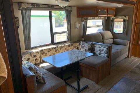 The dining area transforms into a queen bed.