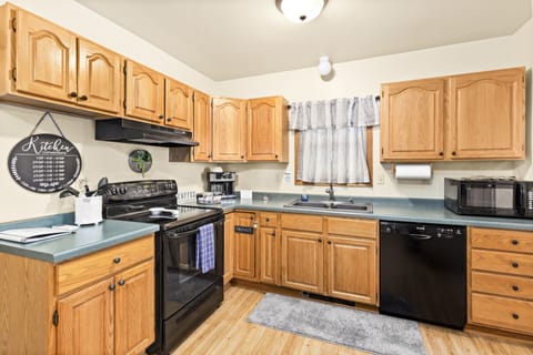 Fully stocked kitchen with flattop Stove, oven, full refrigerator and dishwasher