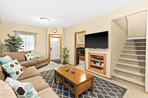 Living room with a 55” Flatscreen TV, Roku and DVD player