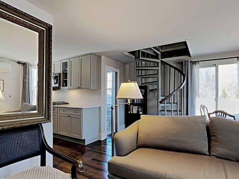 Open comfy space with wide floor boards and spiral access to the large loft.