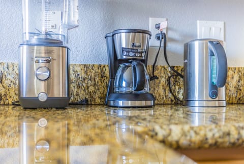 The kitchen is equipped with stainless steel appliances and cookware