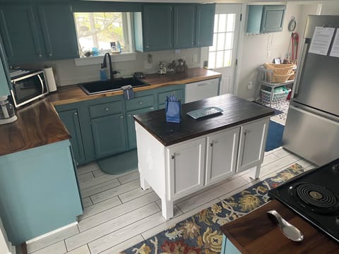 Love to cook? The butcher block topped island makes the kitchen super functional
