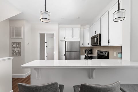 【Kitchen】Fully stocked kitchen opens directly to the dining and living area.