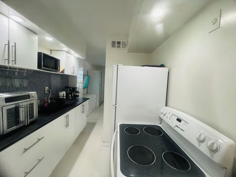 Fully equipped kitchen with cooktop, convection/air fryer oven, microwave...