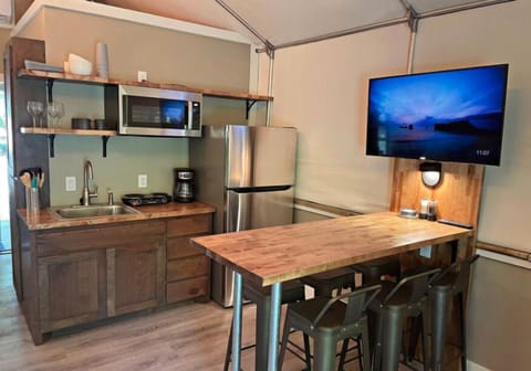 Full refrigerator, microwave, hot plate, pots, pans, utensils etc.