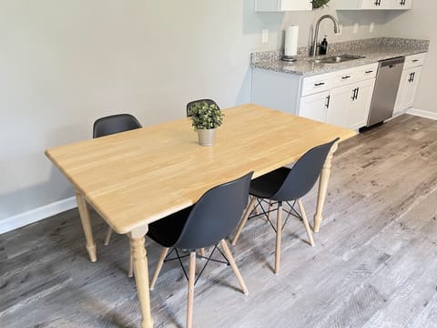 Dining table, seats 6 max, chairs provided.