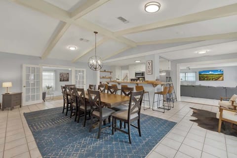 The spacious open-concept kitchen and dining area provide the perfect setting to gather with friends and family while preparing a delicious meal.