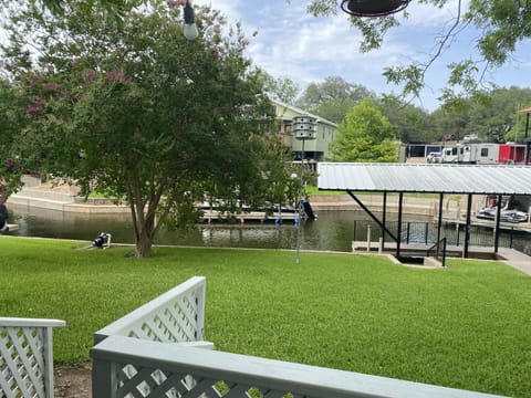 Backyard along channel.  Boat slips in use by owners.