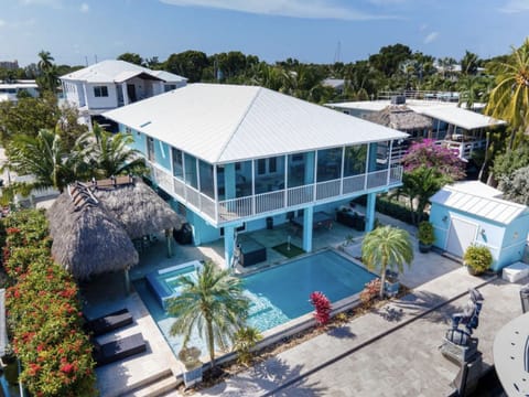 Rear patio, pool, tiki bar, dock and shed